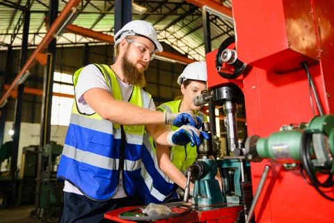 Mechanical engineers repairing engine machine at factory 写真素材