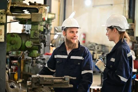 Mechanical engineers repairing engine machine at factory 写真素材
