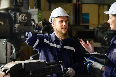 Mechanical engineers repairing engine machine at factory 写真素材