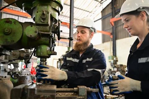 Mechanical engineers repairing engine machine at factory 写真素材
