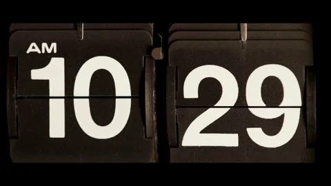 Mechanical flip clock changes from ten twenty nine AM Stock Footage 329673673