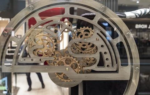 Mechanical gears making into a complex watch machine closeup view Stock Photos