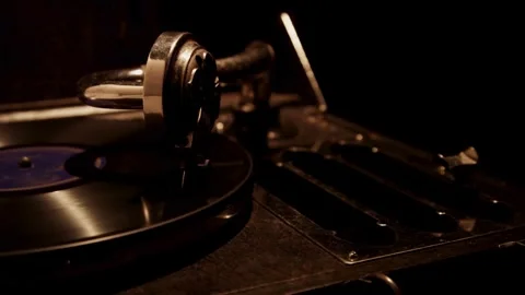 Mechanical gramophone arm playing black record in dark room Stock Footage 329559064