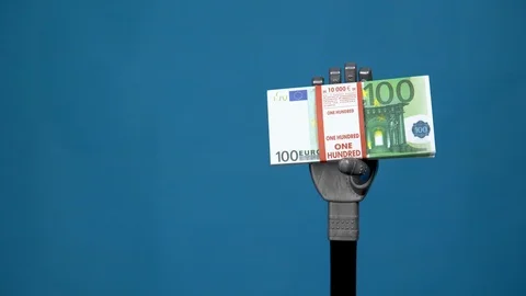 A mechanical hand holds a bundle of euros. A gray cyborg hand holds money on a Stock Footage 126661743