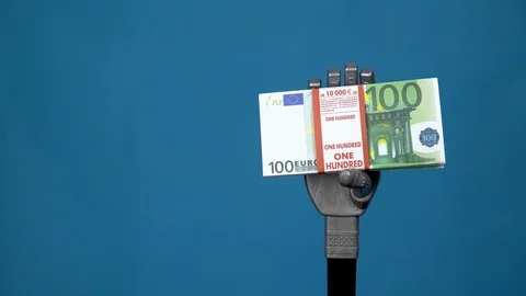 A mechanical hand holds a bundle of euros. A gray cyborg hand holds money on a Stock Footage 126661787
