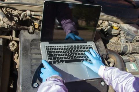 Mechanical hitch engine diesel tests using laptop on the air filter with t Stock Photos