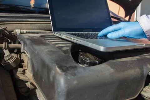 Mechanical hitch engine diesel tests using laptop on the air filter with t Stock Photos