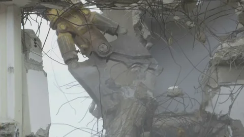 Mechanical jaws attached to an excavators arm grabbing the concrete block Stock Footage 81750970