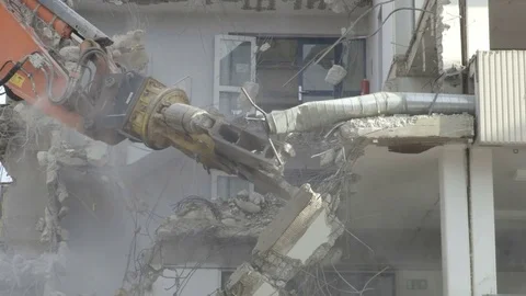 Mechanical jaws attached to an excavators arm crashing the floor of the building Stock Footage 81751229