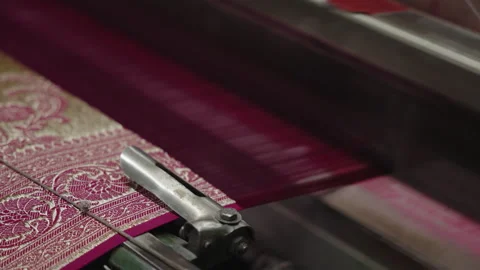 A mechanical machine makes silk fabric in an Indian factory. Fabric Yarn Stock Footage 303869913