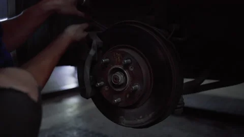 Mechanical man maintenance car brake in garage car fix Stock Footage 236737704