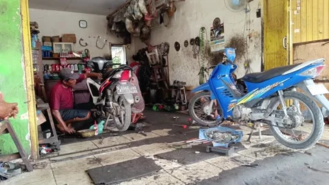 Mechanical man repairing a motorcycle engine Stock Footage 293459526