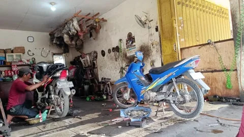 Mechanical man repairing a motorcycle engine Stock Footage 293460242