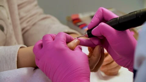 Mechanical manicure in the process of polishing the cuticle. Close up Stock Footage 102266328