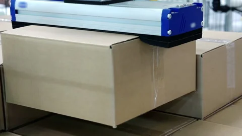 Mechanical manipulator stacks cardboard boxes. Stock Footage 156545176