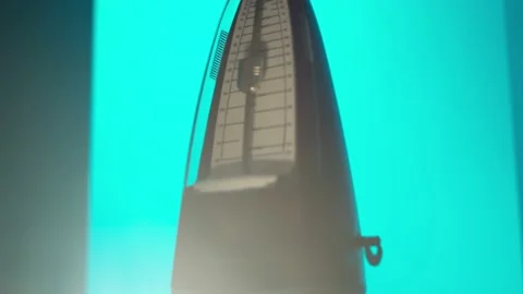 Mechanical metronome in the smoke on the shelf of the studio zooming in Stock Footage 156937485