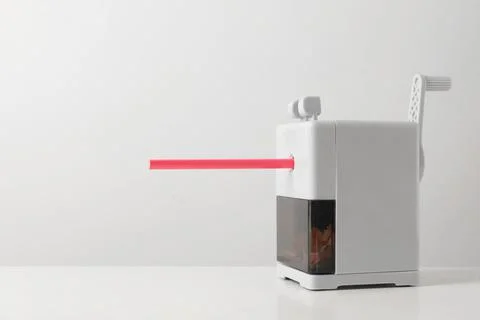 Mechanical sharpener with pencil on white table. Space for text Stock-Fotos