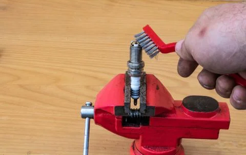 Mechanical spark plug cleaning technology with a metal brush Stock Photos