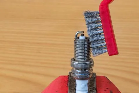 Mechanical spark plug cleaning technology with a metal brush Stock Photos