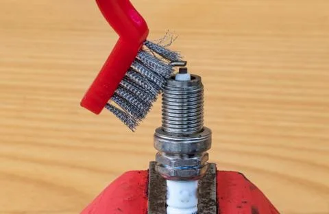 Mechanical spark plug cleaning technology with a metal brush Stock Photos