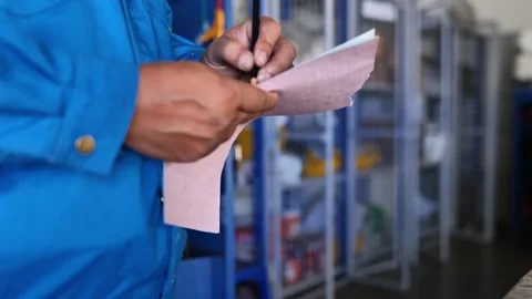 Mechanical Technician Inspecting Workshop Tools and Recording on Checklist Stockbeeldmateriaal 297919734