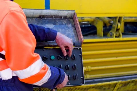 Mechanical technician operating on a control panel Stock Photos