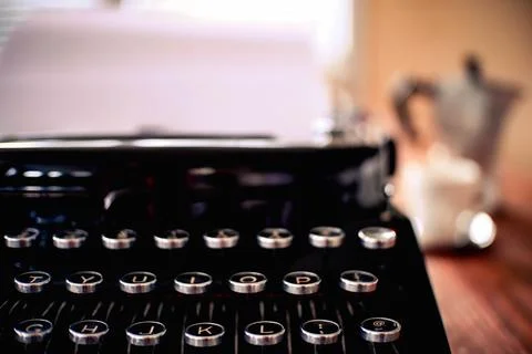 Mechanical typewrite with espresso tools and warm light Stock Photos