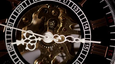 Mechanical watch gears moving behind a black clock face Stock Footage 329596091