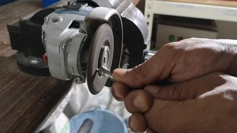 A mechanical worker sharpens the drill bit using a grinder manually. Stock Footage 121489280