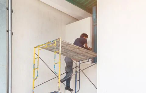Mechanics are helping to install the isolate wall at the factory. Stock Photos