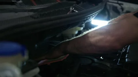 Mechanic's Arm Reaching Deep Inside a Car Engine Bay Stock Footage 318309734