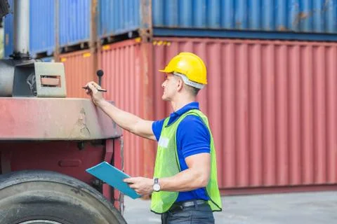 Mechanics checking wheel in cargo container. Professional technician pre-chec Фото