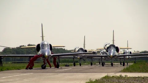 Mechanics deploy fuselage of L-39 aircraft in direction of taxiing. Stock Footage 121246981