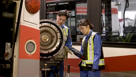 Mechanics fixing bus engine in maintenance facility Stock Footage 221035388