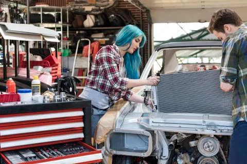 Mechanics fixing car engine in auto repair shop Stock Photos