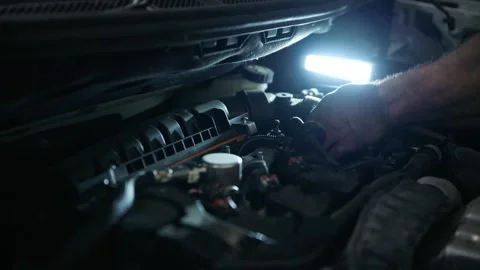Mechanic's Hand Working Deep Inside a Car Engine Bay Stock Footage 318309702