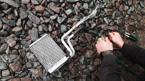 Mechanics hands during car heating system repair. Cleaning car heater under Stock Footage 322093044