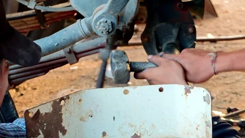 Mechanic's hands using tools to perform maintenance on a truck engine in a Stock Footage 343080985