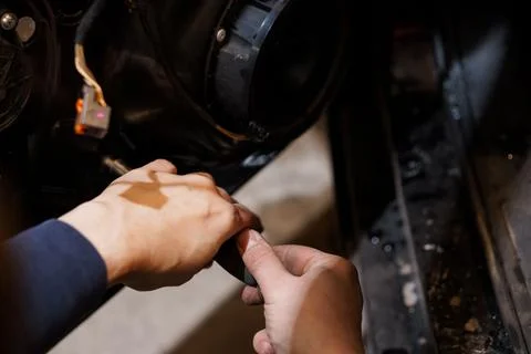 A Mechanic's Hands Working on a Car Engine Component 스톡 사진