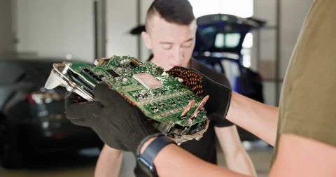 Mechanics Inspecting Electric Car Engine Circuit Board Repair Stock Footage 277211952