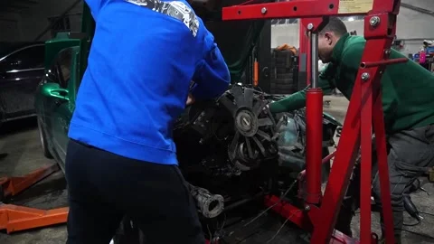 Mechanics install a new turbo engine Stock Footage 235676841