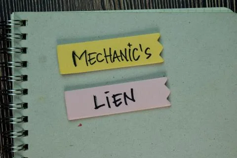 Mechanic's Lien write on a book isolated on Wooden Table. Foto stock