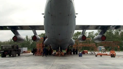 Mechanics perform maintenance on left main chassis Il-76 aircraft.from ladder. Stock Footage 108802409