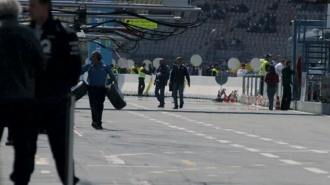 Mechanics at Pitstop at Car Race - Slow Motion - Racing engineers Stock Footage 158772263