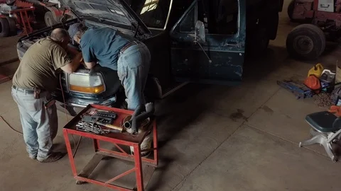 Mechanics reparing an old car Stock Footage 93976857