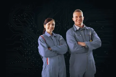 Mechanics standing in front of a circuit board background Stock Photos