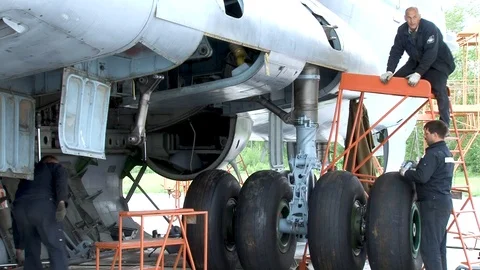 Mechanics work on main landing gear of  Il-76 aircraft. Stock Footage 108428971
