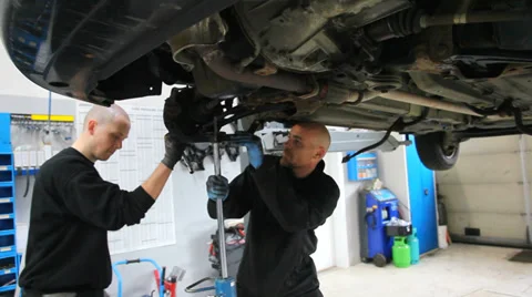 Mechanics working on the suspension Stock Footage 36351044