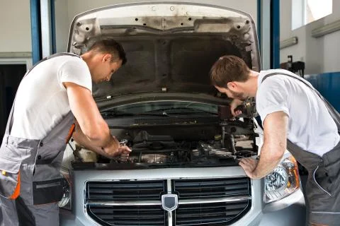 Mechanics working together Stock Photos
