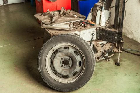 Mechanic's workshop with a table full of tools and a wheel Stock Photos